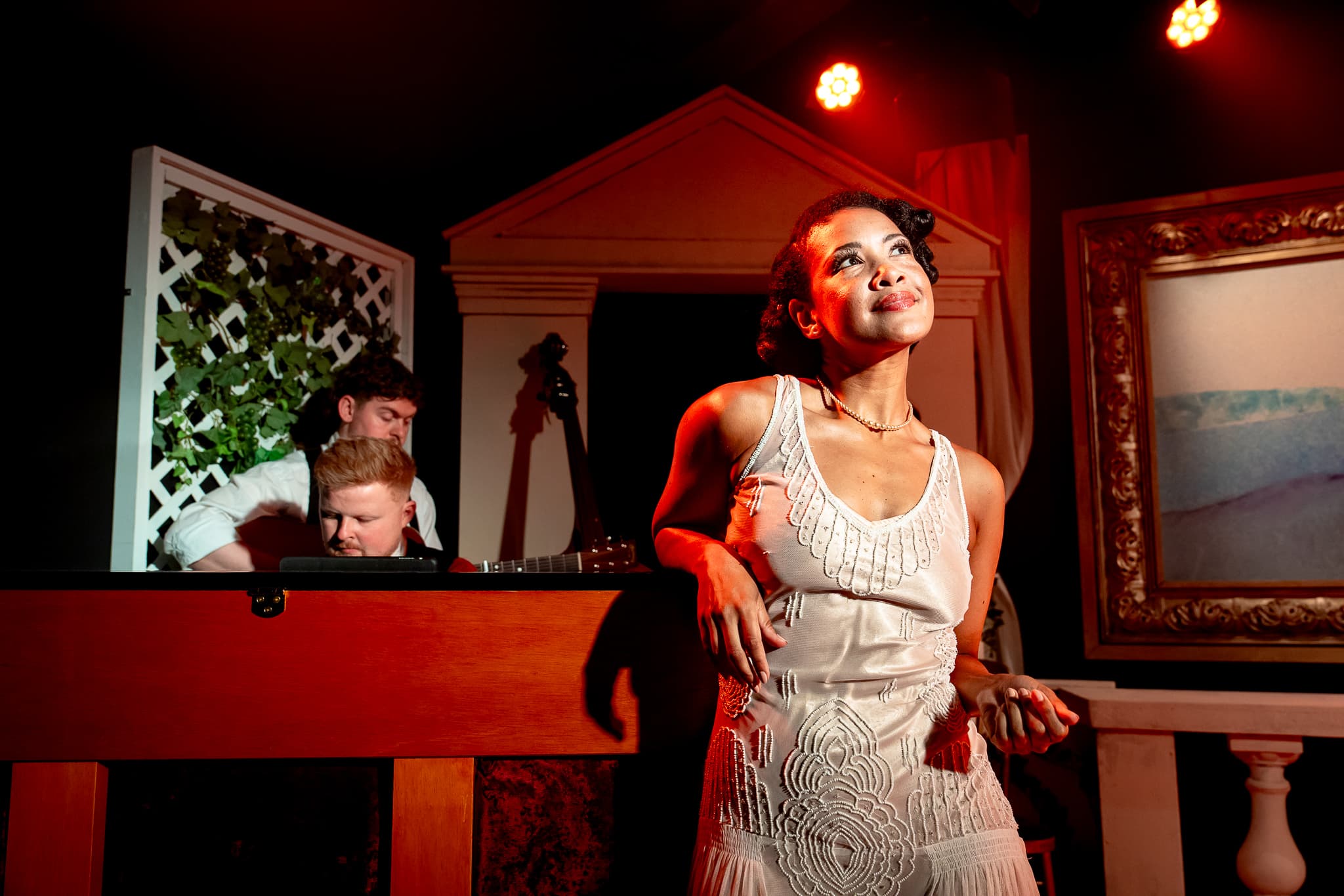 A performer standing beside the bar during Extraordinary Women