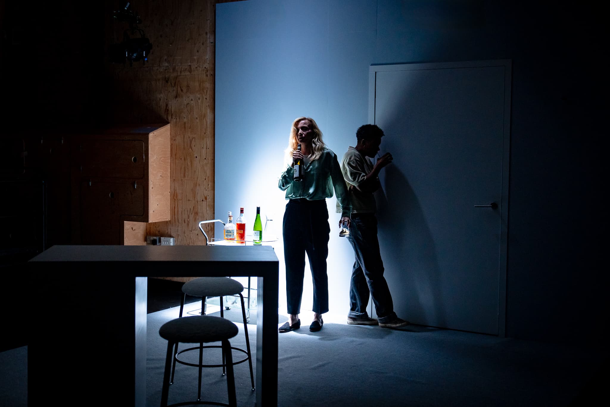Two performers in a stark domestic interior