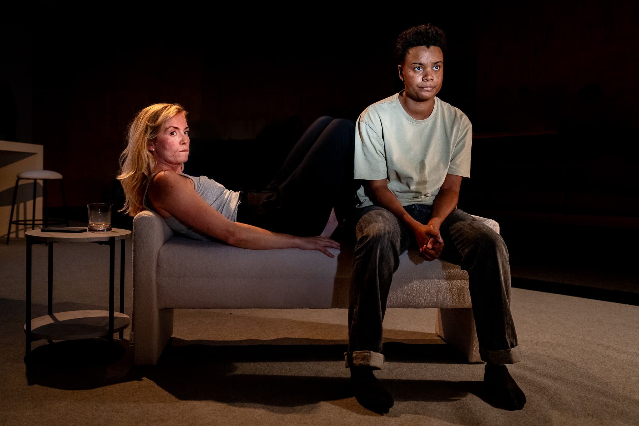 Two performers sitting apart in a tense domestic scene
