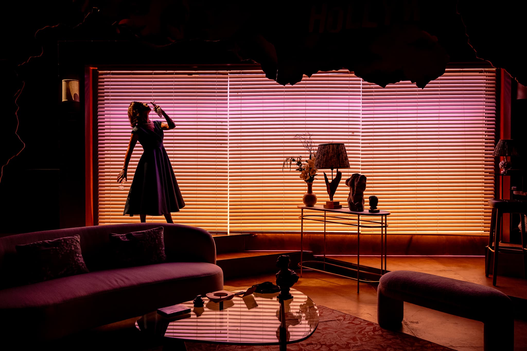 A solitary figure silhouetted against the blinds in The Code
