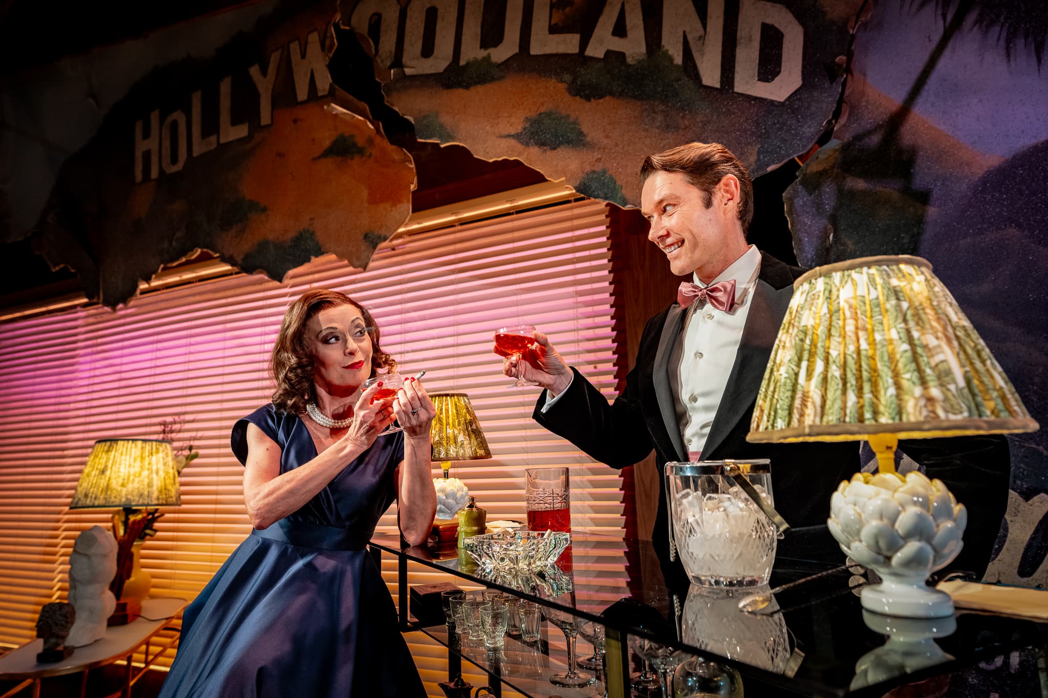 A performer behind a drinks trolley in The Code